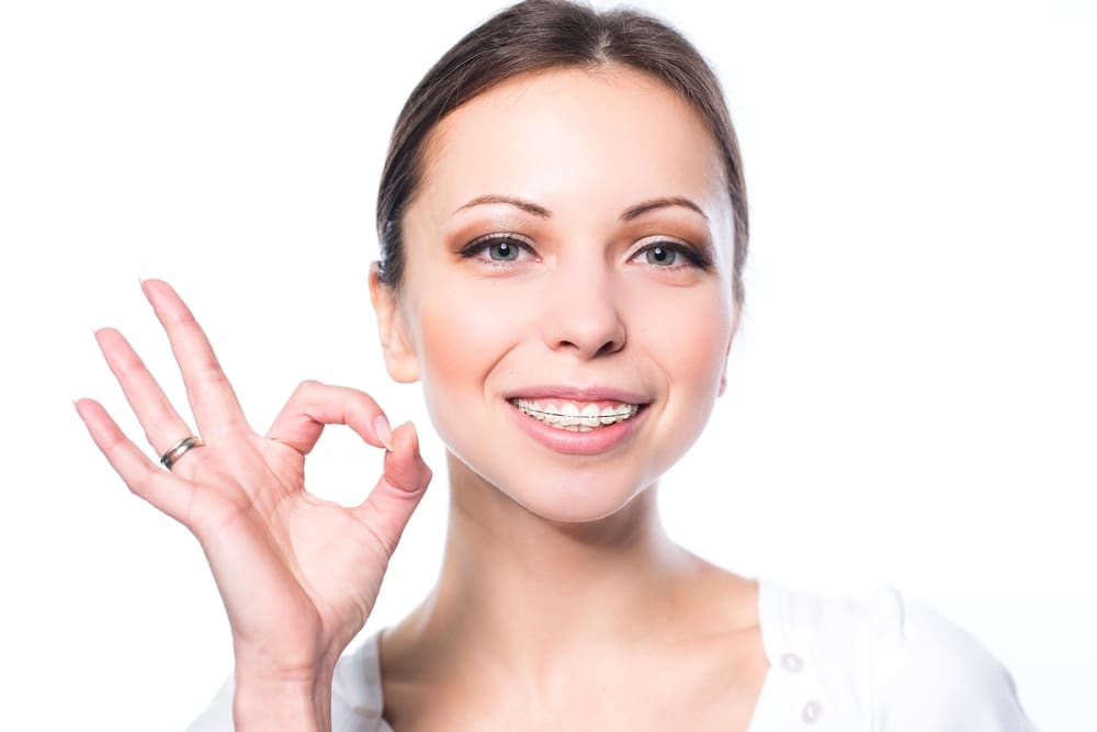 a woman with braces from orthodontist in Fort Myers, FL smiling at the camera